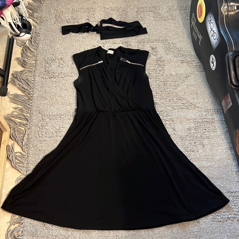 Calvin Klein black dress with belt in fine condition. Size medium.
